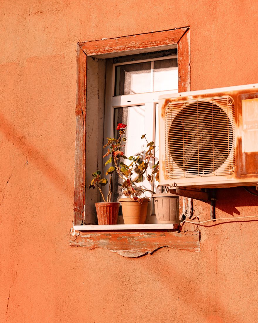 An air-conditioning unit on a home in the sun